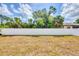 Expansive backyard featuring a pristine white fence providing privacy and security, perfect for outdoor activities at 129 David Blvd, Rotonda West, FL 33947