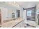 Bathroom with a granite vanity, tile floor and shower/tub combo at 129 David Blvd, Rotonda West, FL 33947