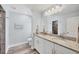Bright bathroom featuring double granite vanity, white cabinets, and a walk-in tiled shower at 129 David Blvd, Rotonda West, FL 33947