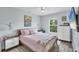Cozy bedroom with a ceiling fan and view to the outside at 129 David Blvd, Rotonda West, FL 33947