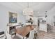 Stylish dining area with modern furnishings, a chandelier, and seamless transition to the adjacent kitchen space at 129 David Blvd, Rotonda West, FL 33947