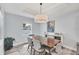 Comfortable dining area with a modern chandelier, neutral decor, and a view of the backyard at 129 David Blvd, Rotonda West, FL 33947