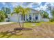Lovely single-story home with an attached two car garage and a cozy front porch area at 129 David Blvd, Rotonda West, FL 33947