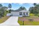 Charming single-story home featuring a well-manicured lawn and a two car garage at 129 David Blvd, Rotonda West, FL 33947