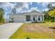 Beautiful single-story home boasting a covered porch and an attached two car garage at 129 David Blvd, Rotonda West, FL 33947