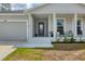 Covered porch area with seating offering a cozy and inviting entrance to the home at 129 David Blvd, Rotonda West, FL 33947