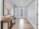 Inviting hallway with wood-look flooring, decorative accents, and ample natural light at 129 David Blvd, Rotonda West, FL 33947
