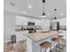Modern kitchen with stainless steel appliances, granite countertops, and stylish island with bar stool seating at 129 David Blvd, Rotonda West, FL 33947