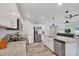 Well-equipped kitchen featuring stainless steel appliances, granite counters, and an open design flowing into the living area at 129 David Blvd, Rotonda West, FL 33947