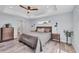 Tranquil main bedroom featuring tray ceiling, wood-look floors, and neutral color palette for a relaxing retreat at 129 David Blvd, Rotonda West, FL 33947