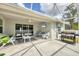 Inviting screened patio with seating, mounted TV and BBQ grill for outdoor enjoyment at 129 David Blvd, Rotonda West, FL 33947
