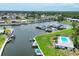 Aerial view of waterway community with boat docks, pool, clubhouse, and multiple residences at 149 Englewood Isles Pkwy # 603, Englewood, FL 34223