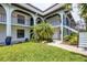 Charming condo courtyard with lush green lawn and mature tropical landscaping at 149 Englewood Isles Pkwy # 603, Englewood, FL 34223