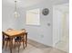 Bright dining area features a wooden table with seating for four and a stylish chandelier at 149 Englewood Isles Pkwy # 603, Englewood, FL 34223