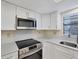 Bright kitchen featuring stainless steel appliances, modern countertops, and cabinetry at 149 Englewood Isles Pkwy # 603, Englewood, FL 34223