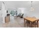 Open-concept living and dining area with sleek flooring and sliding glass doors to balcony at 149 Englewood Isles Pkwy # 603, Englewood, FL 34223