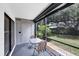 Relaxing screened-in patio with table and chairs and door to outside at 149 Englewood Isles Pkwy # 603, Englewood, FL 34223