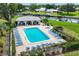 Community pool aerial view with lounge chairs, spa and boat docks at 149 Englewood Isles Pkwy # 603, Englewood, FL 34223