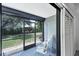 Relaxing screened porch with comfortable seating, views of the lush backyard, and a storage area at 149 Englewood Isles Pkwy # 603, Englewood, FL 34223