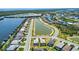 An aerial view features stunning waterfront homes with boat docks, nestled within a beautifully designed community at 15176 Spanish Point Dr, Port Charlotte, FL 33981
