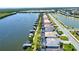 A picturesque aerial view of waterfront homes along a canal, showcasing private boat docks and manicured lawns at 15176 Spanish Point Dr, Port Charlotte, FL 33981