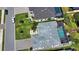 Aerial view showcases a gray roof, lush lawn, manicured landscaping, and screened in lanai with private pool at 15176 Spanish Point Dr, Port Charlotte, FL 33981