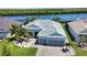 Lovely aerial view of a single-story home with a well-kept yard and a picturesque river in the background at 15176 Spanish Point Dr, Port Charlotte, FL 33981