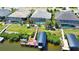 An aerial view shows a waterfront home with a private boat dock, boat lift, and screened-in pool at 15176 Spanish Point Dr, Port Charlotte, FL 33981