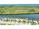 An aerial perspective of luxurious waterfront houses with boat docks, set against a backdrop of natural beauty at 15176 Spanish Point Dr, Port Charlotte, FL 33981
