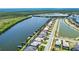 Aerial view showcases waterfront homes with private boat docks along a waterway in a residential community at 15176 Spanish Point Dr, Port Charlotte, FL 33981
