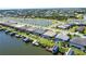 Aerial view of waterfront homes with private boat docks, boat lifts, and screened-in swimming pools at 15176 Spanish Point Dr, Port Charlotte, FL 33981