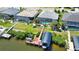 An aerial view of a waterfront home with private dock, boat lift, and screened-in lanai with pool at 15176 Spanish Point Dr, Port Charlotte, FL 33981