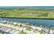 This aerial captures stunning waterfront residences with boat docks, surrounded by lush greenery and serene canals at 15176 Spanish Point Dr, Port Charlotte, FL 33981