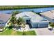 Stunning aerial view of a single-story home with a tile roof, lush landscaping, and a waterfront view at 15176 Spanish Point Dr, Port Charlotte, FL 33981