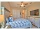 Bright, well-lit bedroom with coastal decor featuring a large bed and dresser at 15176 Spanish Point Dr, Port Charlotte, FL 33981