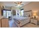Comfortable bedroom with coastal accents, featuring a charming ceiling fan and pool view at 15176 Spanish Point Dr, Port Charlotte, FL 33981