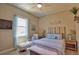 Calm bedroom features stylish coastal decor, soft blue hues, and a cozy reading nook at 15176 Spanish Point Dr, Port Charlotte, FL 33981