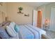 Inviting bedroom with soothing colors, a cushioned bench, and decorative wall shelves at 15176 Spanish Point Dr, Port Charlotte, FL 33981
