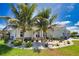 Charming single-story home with decorative rock landscaping, lush plantings, and a three-car garage at 15176 Spanish Point Dr, Port Charlotte, FL 33981