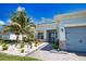 Charming single-story home with well-manicured landscaping, stone accents, and a paved walkway leading to the front door at 15176 Spanish Point Dr, Port Charlotte, FL 33981