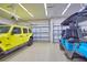 Spacious garage with epoxy flooring, a yellow Jeep Wrangler, and a golf cart offering ample parking at 15176 Spanish Point Dr, Port Charlotte, FL 33981