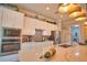 Modern kitchen island with stone countertops and stainless appliances at 15176 Spanish Point Dr, Port Charlotte, FL 33981