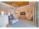 Open-concept living room features a wooden ceiling, wood-look flooring and a decorative chandelier at 15176 Spanish Point Dr, Port Charlotte, FL 33981
