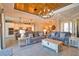 Spacious open-concept living room with wood-plank ceiling, tile floors, and open to the kitchen at 15176 Spanish Point Dr, Port Charlotte, FL 33981