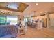 Open floor plan featuring a spacious living room, kitchen island with seating and backyard views at 15176 Spanish Point Dr, Port Charlotte, FL 33981
