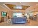 Open-concept living room with wood-plank ceiling, tile floors, chandelier, and sliding doors to the lanai at 15176 Spanish Point Dr, Port Charlotte, FL 33981