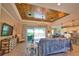 Bright open-concept living room with wood-plank ceiling, tile floors, chandelier, and sliding doors to the lanai at 15176 Spanish Point Dr, Port Charlotte, FL 33981