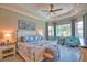 Beautiful main bedroom with tray ceiling, ceiling fan and large windows creating a bright and airy space at 15176 Spanish Point Dr, Port Charlotte, FL 33981