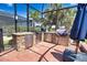 This brick outdoor kitchen features stainless steel appliances and ample counter space, perfect for entertaining and grilling at 15176 Spanish Point Dr, Port Charlotte, FL 33981