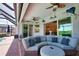 Relaxing covered patio with comfortable outdoor seating and a view of the pool and waterfront, perfect for enjoying the outdoors at 15176 Spanish Point Dr, Port Charlotte, FL 33981